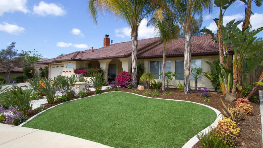 House with palm trees and manicured lawn